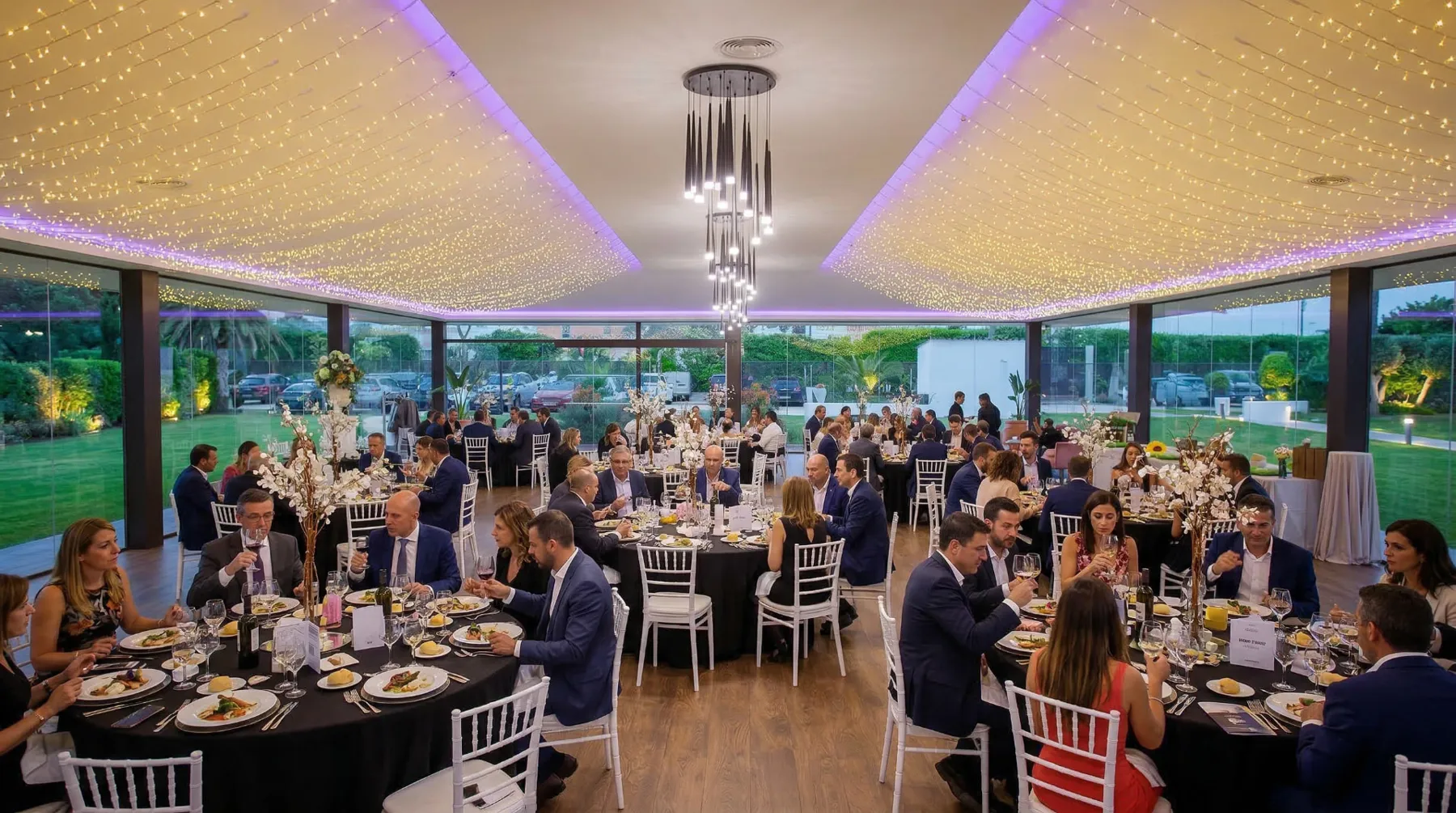 Salón de una finca de InBodas montado con mesas y escenario para un evento de empresa